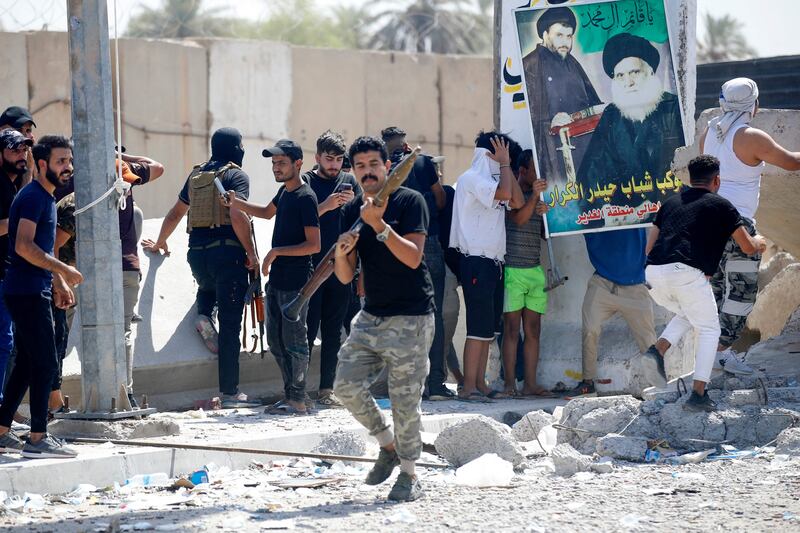 Members of Saraya Al Salam, affiliated with Moqtada Al Sadr, clash with Iraqi security forces in Baghdad's Green Zone on Tuesday. AFP