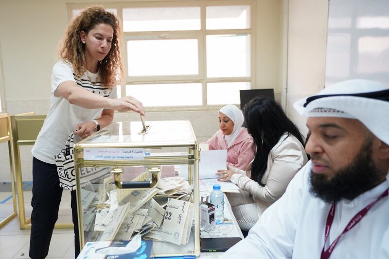 A woman votes during parliamentary elections at a polling station in Kuwait City. Reuters