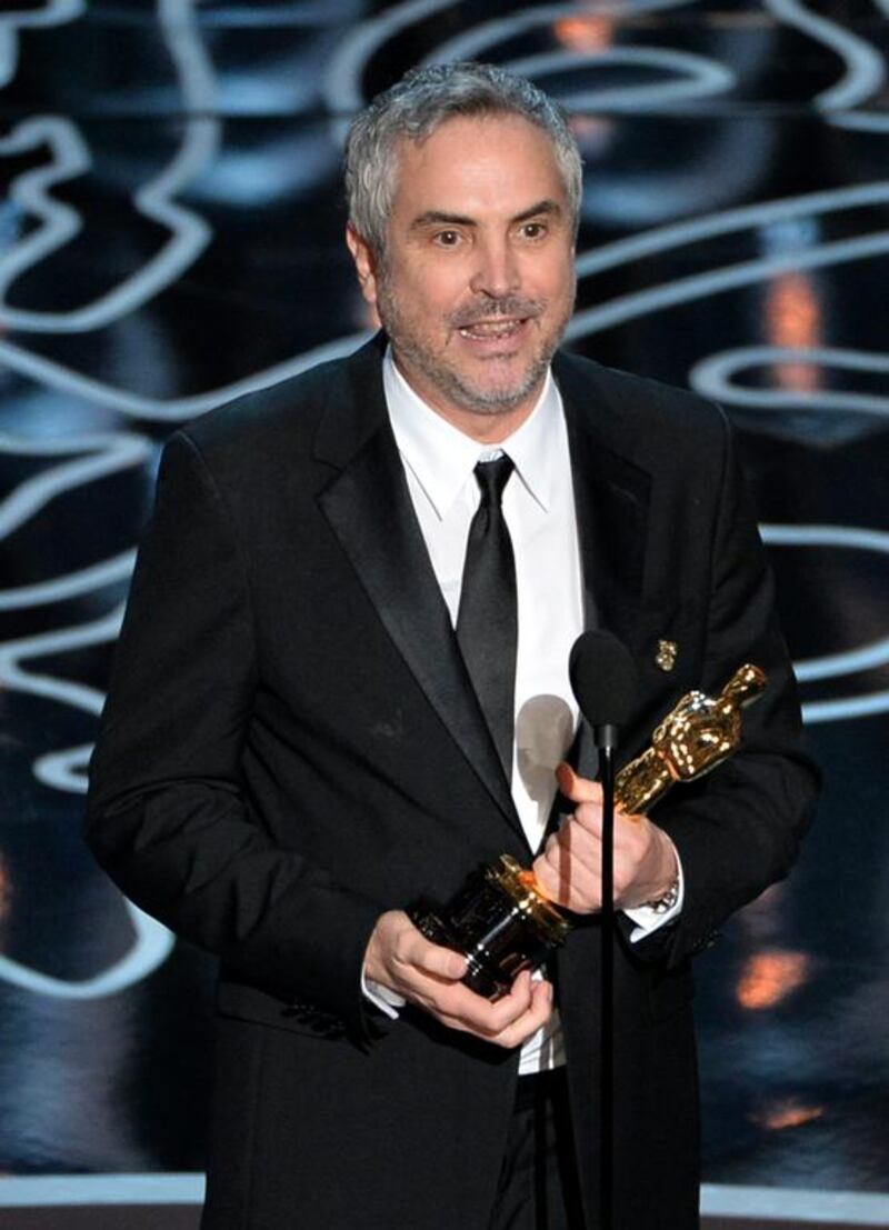 Director Alfonso Cuaron accepts the Best Achievement in Directing award for Gravity. Kevin Winter / Getty Images / AFP