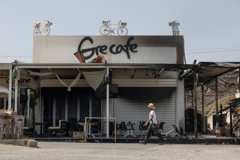 Burnt-out shops along the coast road in Kiotari, Rhodes, after the Greek island was ravaged by wildfires
