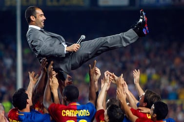 Barcelona's coach Pep Guardiola is tossed by players during celebrations of the Spanish first division soccer league win at Camp Nou stadium in Barcelona May 23, 2009. Barcelona were gifted their 19th Liga title without kicking a ball on May 16 when second-placed Real Madrid were beaten 3-2 at Villarreal. REUTERS/Albert Gea (SPAIN SPORT SOCCER IMAGES OF THE DAY)
