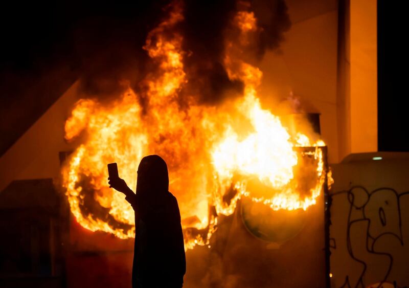 A building in Centennial Olympic Park burns during rioting and protests in Atlanta.   AFP