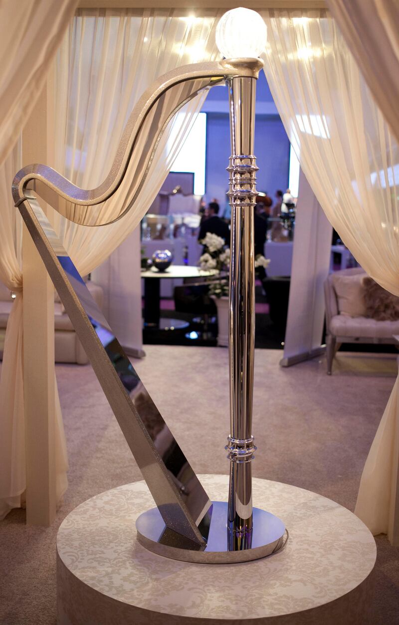 Dubai, United Arab Emirates - January 15 2012 - A floor lamp in the shape of a harp made with Morano glass and a chrome finish is on display at the World Luxury Expo in Burj Al Arab. It is worth 10,000 USD.  (Razan Alzayani / The National)