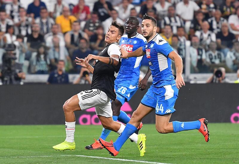 Juventus' Paulo Dybala and Napoli's Kostas Manolas in action. EPA