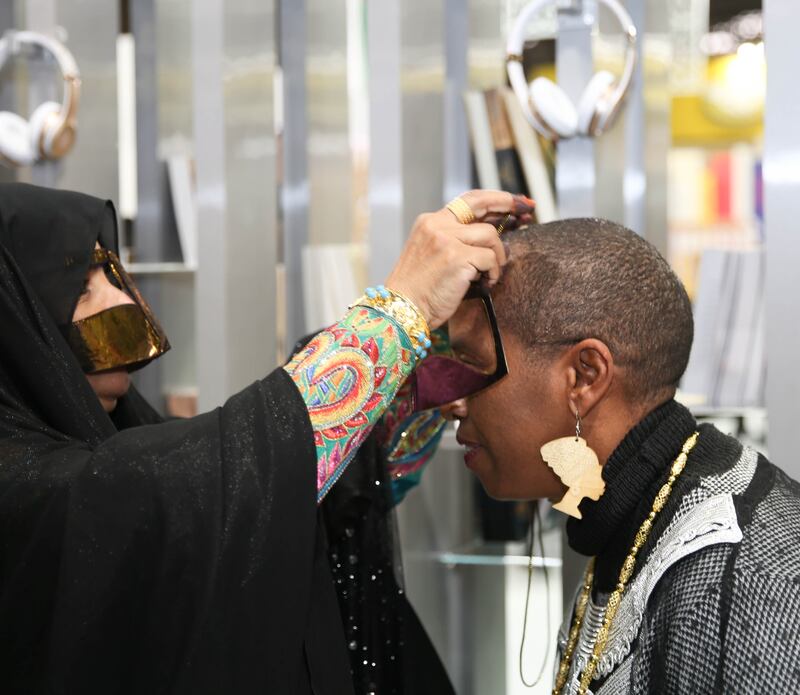 An Irthi artisan introduces a visitor to Emirati traditional costume at the Sao Paulo International Book Fair in 2018. Photo: Irthi Contemporary Crafts Council