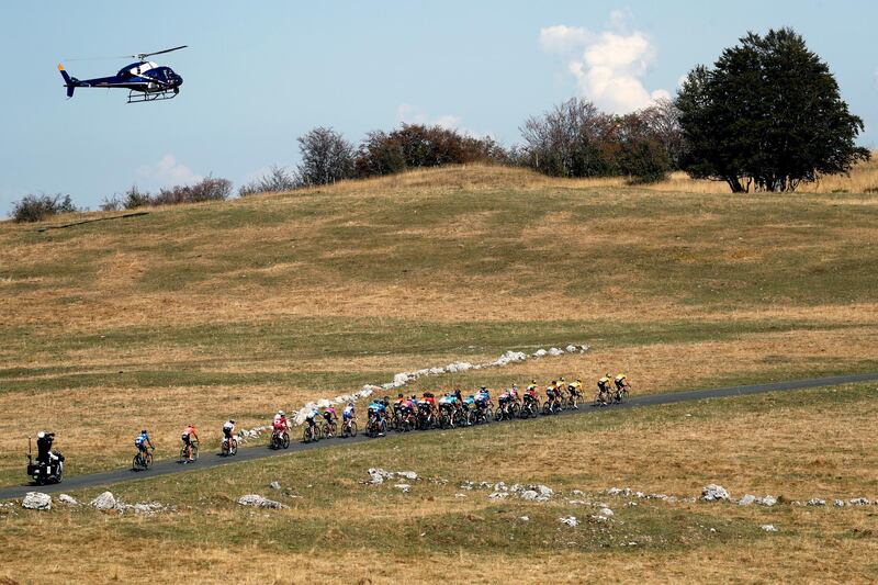 A helicopter flies over the peloton. AP