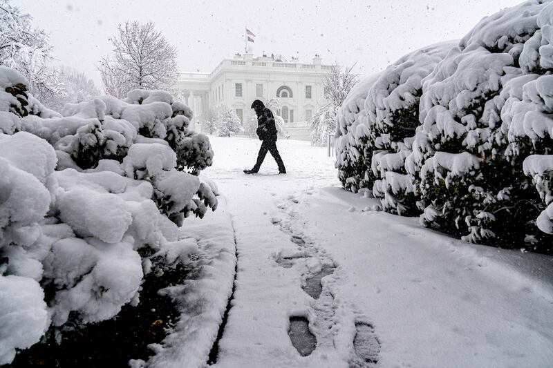 Snow falls at the White House in Washington. AP