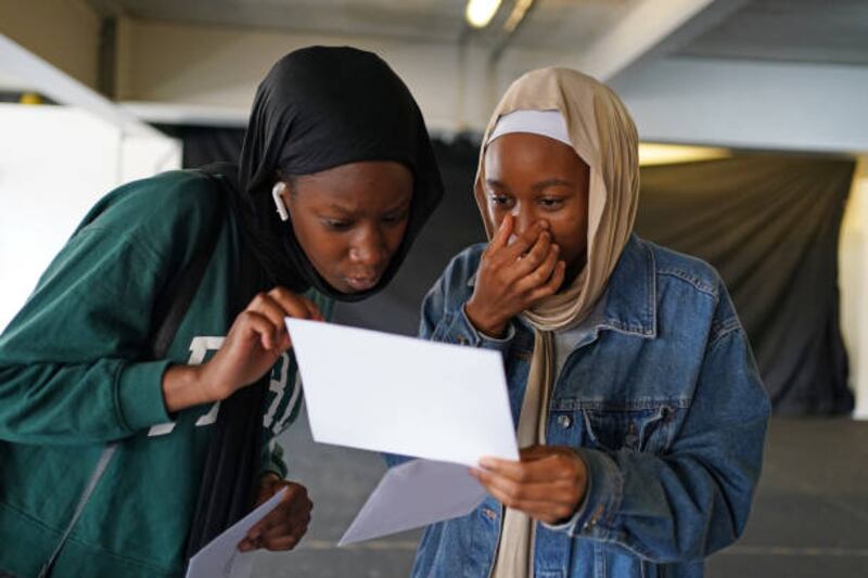 Hajara Yousouf, right, and a friend open their GCSE results at Core's City Academy in Birmingham.