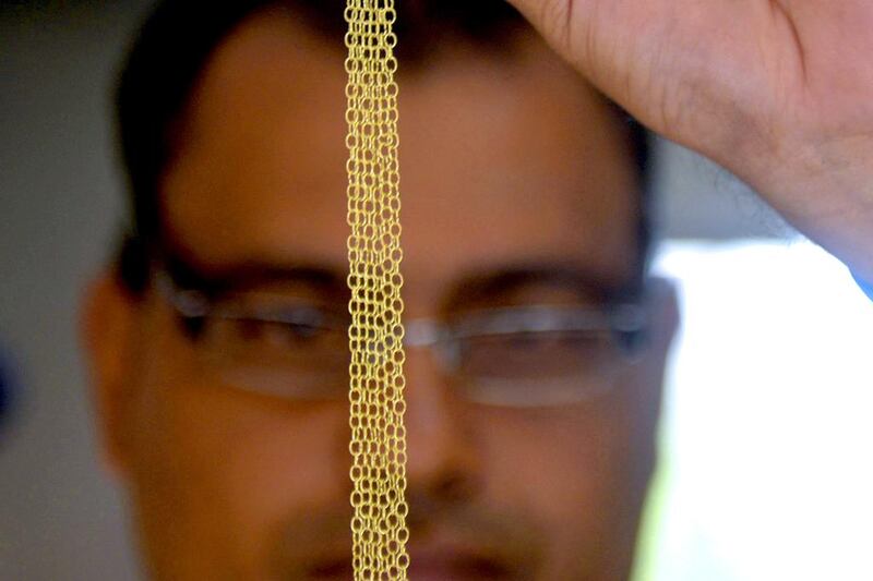 A craftsman works on a gold chain in Antioquia. Colombia produces some 66 metric tonnes of gold a year, or about US$33billion in exports. Raul Arboleda / AFP