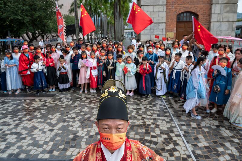 People dressed in traditional Han costumes celebrate China's 73rd National Day in Hong Kong. EPA