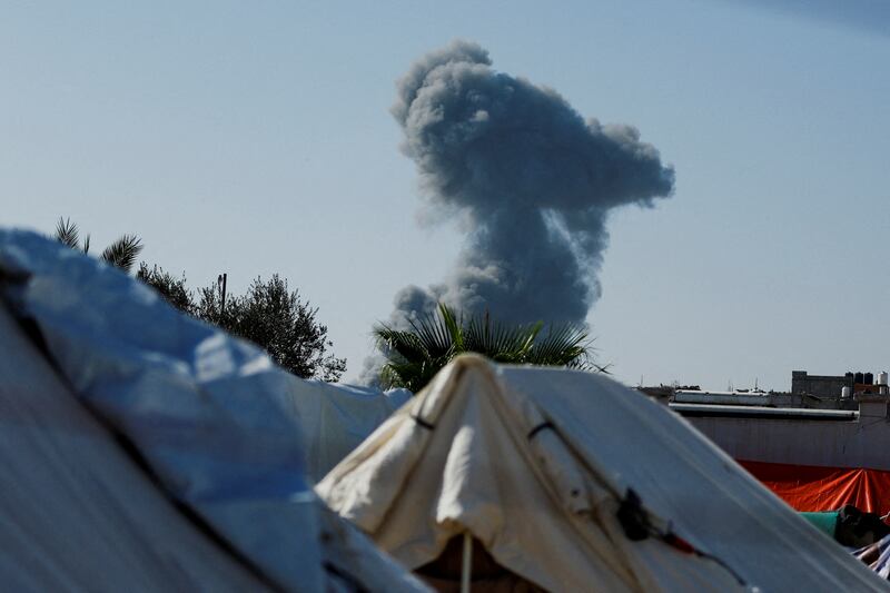 Israeli strikes as seen from a tent camp sheltering displaced Palestinians. Reuters