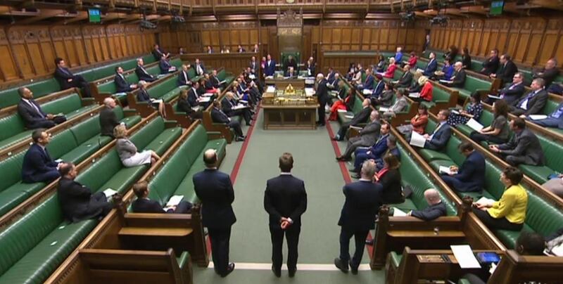 A video grab from footage broadcast by the UK Parliament shows MPs sitting in a largely empty chamber as Prime Minister's Questions starts in the House of Commons in London on March 18, 2020. AFP Photo / PRU