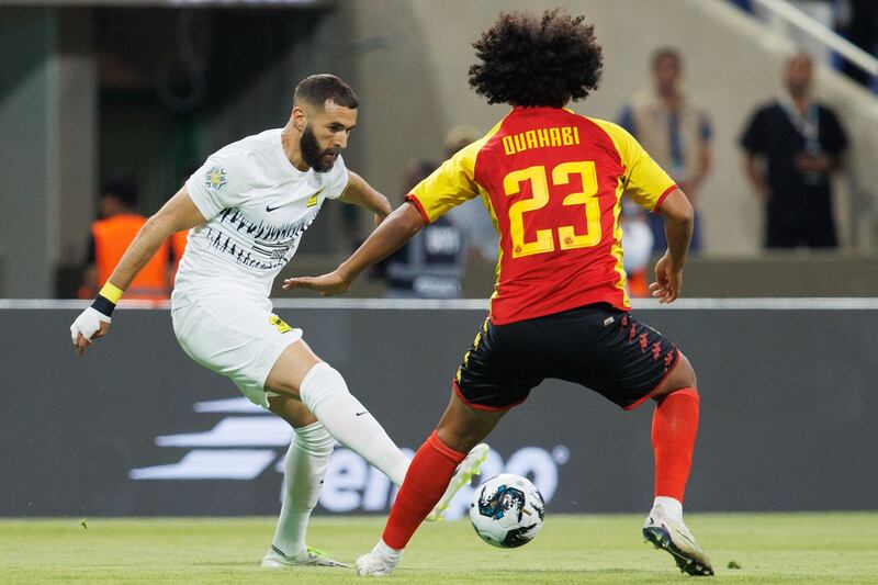 Esperance's Tunisian midfielder Ghaith Ouahabi marks Ittihad's French forward Karim Benzema. AFP