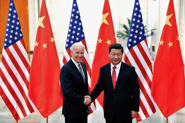 Chinese President Xi Jinping shakes hands with then US Vice President Joe Biden in 2013. Reuters