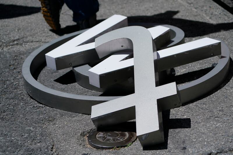 Characters removed from a sign on the Twitter headquarters building piled on a street in San Francisco on July 24. AP