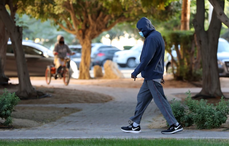 Early morning walks require more layers to keep warm after the temperature falls overnight. Pawan Singh / The National