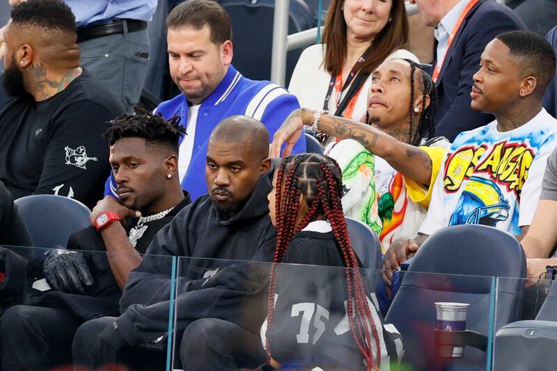 From left, Antonio Brown, Ye and North West among the spectators. Getty Images