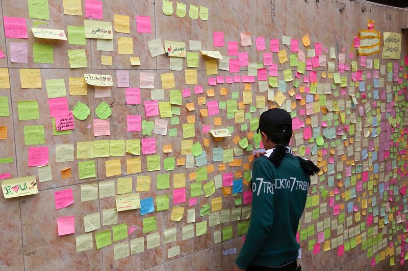 Iraqi protesters write their wishes on notes in Tahrir square in the capital Baghdad. EPA