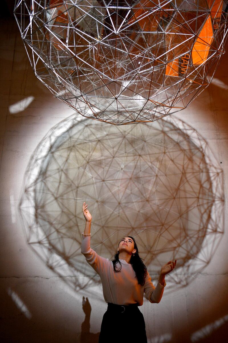 A woman poses with Danish-Icelandic artist Olafur Eliasson's work 'Stardust Particle' (2014) at the Tate Modern in London, Britain, 09 July 2019. Photo: EPA