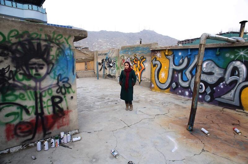 Afghan artist Shamsia Hassani on the roof of her graffiti workshop.