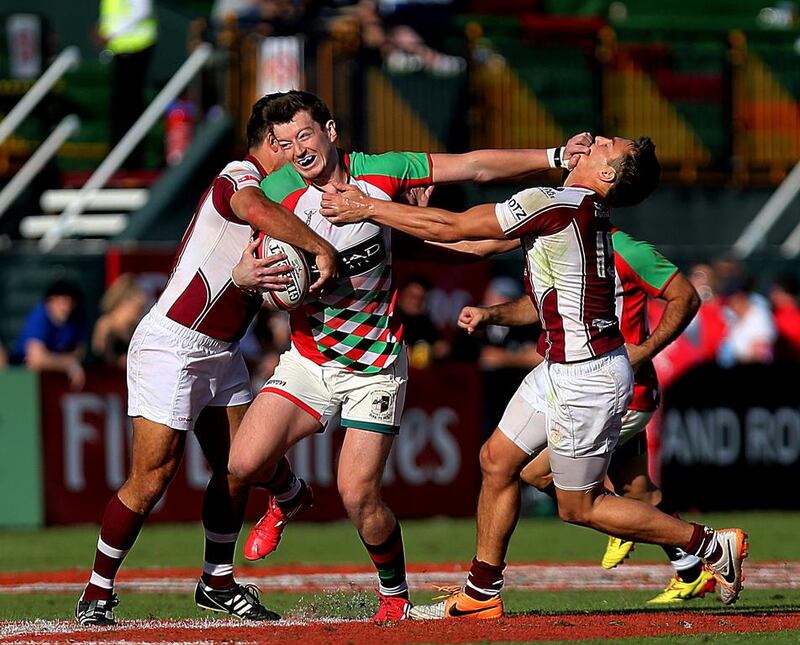 Abu Dhabi Harlequins, in green and Doha, in red, shown in action during their Gulf Men's League Final on Saturday at Dubai Sevens. Harlequins won the match. Satish Kumar / The National