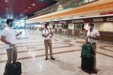 In this handout picture released and taken by Pakistan Cricket Board (PCB) on June 28, 2020, Pakistani cricketers Babar Azam (R), Imad Wasim (L) and Imam-ul-Haq (C) wearing facemasks arrive at the Allama Iqbal International airport before their departure to England, in Lahore. The Pakistan cricket squad left for their England tour on June 28, but without 10 players who had tested positive for coronavirus. / AFP / Handout