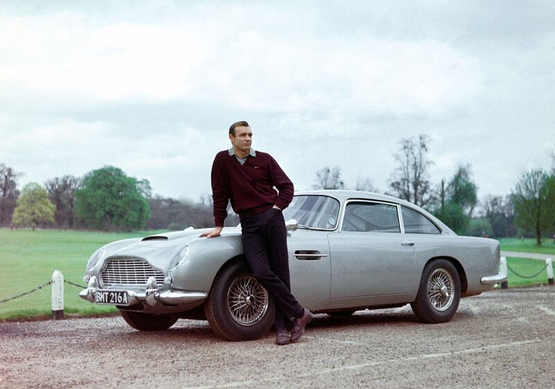 Actor Sean Connery, the original James Bond, is pictured here on the set of Goldfinger with one of the fictional spy's cars, a 1964 Aston Martin DB5. Getty Images