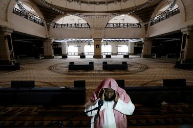 A cleric calls for the prayer at an empty mosque in Riyadh. Reuter
