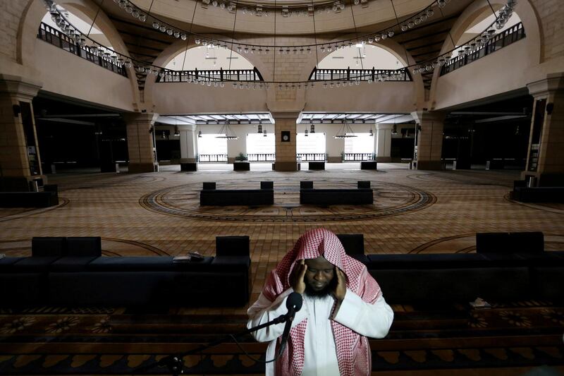 FILE PHOTO: A cleric calls for the prayer at an empty Al-Rajhi Mosque, as Friday prayers were suspended following the spread of the coronavirus disease (COVID-19), in Riyadh, Saudi Arabia, March 20, 2020. REUTERS/Ahmed Yosri/File Photo