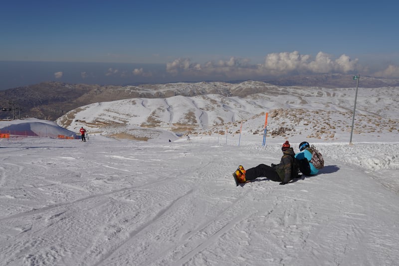 People take a rest on the slopes of the Mzaar Ski Resort.