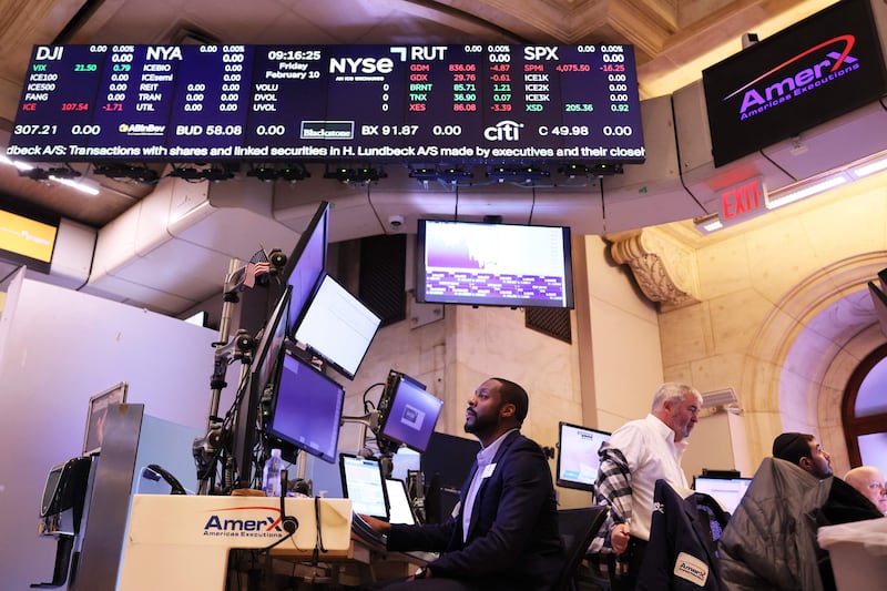 Traders work the floor of the New York Stock Exchange. The US stocks fell on Friday amid concerns about further interest rate hikes by Federal Reserve. Getty Images via AFP
