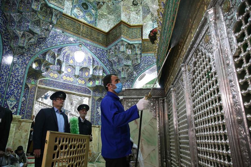 TOPSHOT - Iranian sanitary workers disinfect Qom's Masumeh shrine on February 25, 2020 to prevent the spread of the coronavirus which reached Iran, where there were concerns the situation might be worse than officially acknowledged.  The deaths from the disease -- officially known as COVID-19 -- in the Islamic republic were the first in the Middle East and the country's toll with so far a dozen people officially reported dead, is now the highest outside mainland China, the epidemic's epicentre. / AFP / FARS NEWS AGENCY / MEHDI MARIZAD
