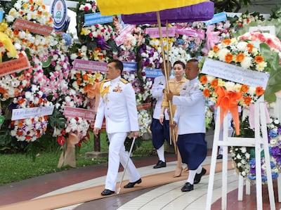 Thailand's King Maha Vajiralongkorn and Queen Suthida arrive at the Siriraj Hospital in Bangkok, Thailand, Thursday, Sept. 24, 2020. King Maha Vachiralongkorn and Queen Suthida are presiding over the wreath laying ceremony on Mahidol day, which the memorable event to his grandfather who was considered as the founding father of Thailand's modern medicine. (Mitichon Newspaper via AP)