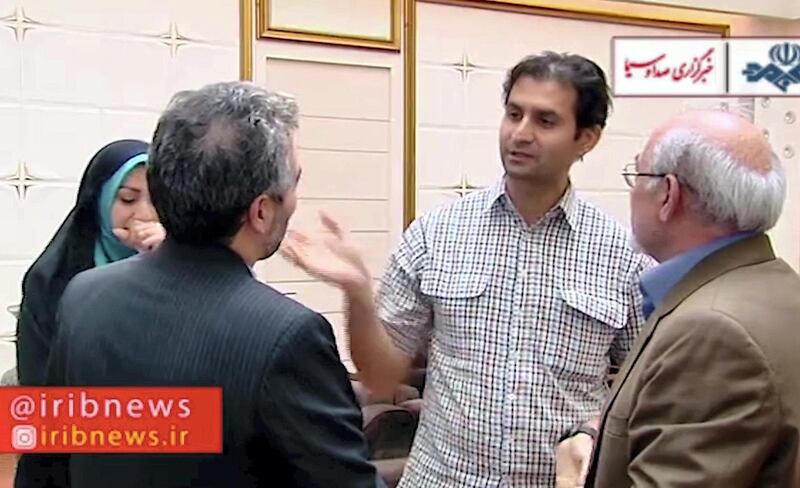 An image grab from footage released by Iranian IRIB TV channel on October 5, 2019 shows what it said was Reza Dehbashi, a PhD student at the University of Queensland in Brisbane, talking to relatives while arriving at Tehran's Imam Khomeini International Airport from Australia following a 13-month detention on accusations of circumventing US sanctions on military equipment. - An Australian travel-blogging couple detained in Iran on spying charges have been released and returned home, Canberra said on October 5, amid reports of the Iranian held in Australia going in the opposite direction. Dehbashi had been working on a "skin cancer detection device" at the time of his arrest and that he had dismissed the charges as "a misunderstanding" and "unfair". (Photo by STRINGER / IRIB TV / AFP) / == RESTRICTED TO EDITORIAL USE - MANDATORY CREDIT "AFP PHOTO / HO / XXX TV" - NO MARKETING NO ADVERTISING CAMPAIGNS - DISTRIBUTED AS A SERVICE TO CLIENTS FROM ALTERNATIVE SOURCES, AFP IS NOT RESPONSIBLE FOR ANY DIGITAL ALTERATIONS TO THE PICTURE'S EDITORIAL CONTENT, DATE AND LOCATION WHICH CANNOT BE INDEPENDENTLY VERIFIED - 
O RESALE/ NO ACCESS ISRAEL MEDIA/PERSIAN LANGUAGE TV STATIONS/ OUTSIDE IRAN/ STRICTLY NI ACCESS BBC PERSIAN/ VOA PERSIAN/ MANOTO-1 TV/ IRAN INTERNATIONAL / 