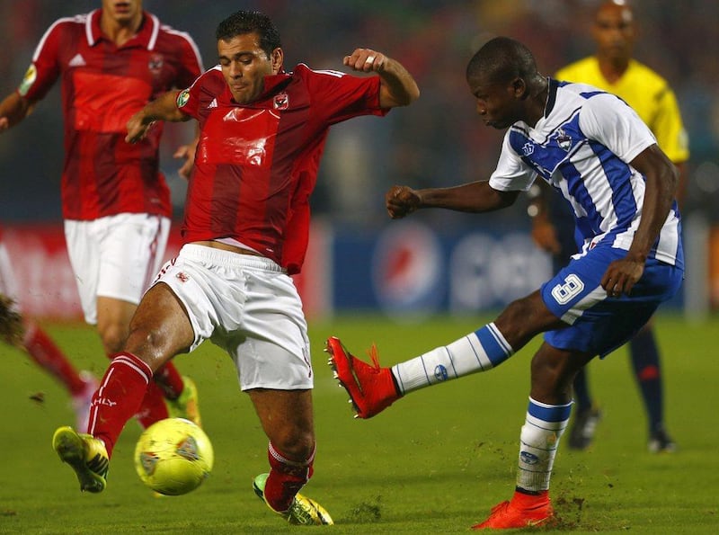 Emad Motaeb of Egypt's Al Ahly fights for the ball with Ibrahim Kone of Ivory Coast's Sewe Sport during the CAF Confederation Cup final on Saturday. Amr Abdallah Dalsh / Reuters