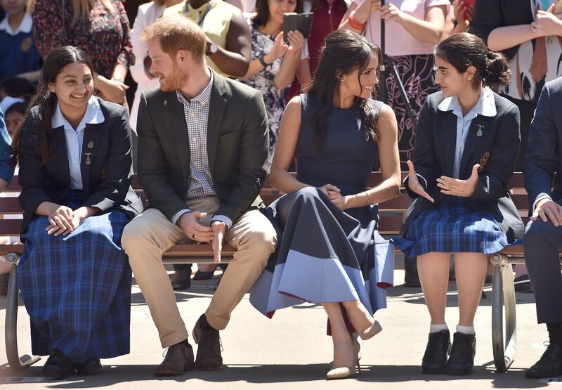 Prince Harry and Meghan speak to pupils on a visit to Macarthur Girls High School in Sydney. AFP