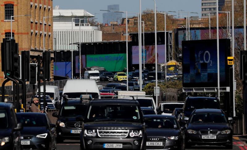 Cars queue in traffic on the main road A4 in London, Thursday, April 22, 2021. European Commission President Ursula von der Leyen said Thursday that the European Union was aiming to reduce its greenhouse gas emissions by at least 55 percent by 2030 as World leaders virtually attend the Leaders Summit on Climate. (AP Photo/Frank Augstein)