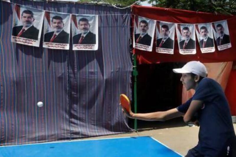 Supporters of Egypt's ousted President Mohammed Morsi play ping pong at their camp in Nahda Square, near Cairo University in Giza, southwestern Cairo.