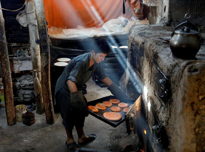 A man prepares cookies at a small traditional factory for the Eid Al Adha in Kabul, Afghanistan. Reuters