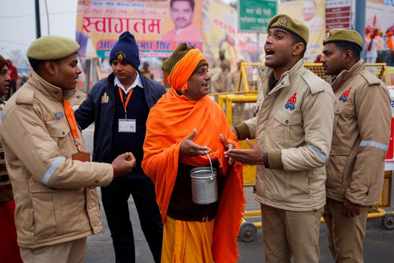 Police officers ask a Hindu holy man to leave the area before the inauguration in Ayodhya. Reuters 