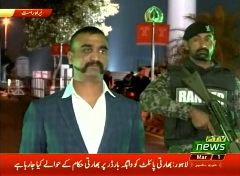 Indian pilot, Wing Commander Abhinandan, stands under armed escort near Pakistan-India border in Wagah, Pakistan in this March 1, 2019 image from a video footage. REUTERS/PTV via Reuters TV   ATTENTION EDITORS - THIS IMAGE HAS BEEN SUPPLIED BY A THIRD PARTY.