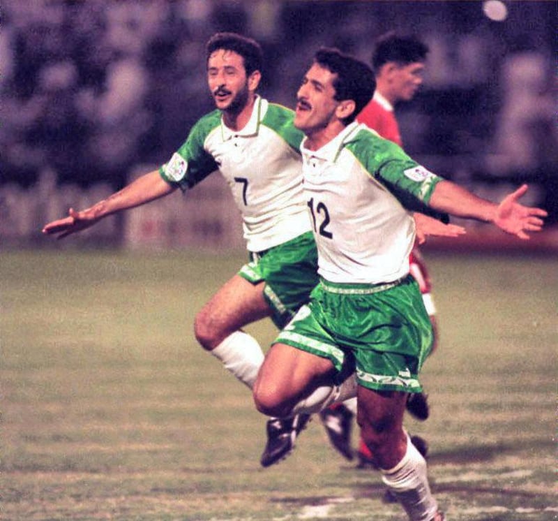 Iraqi forwards Haydar Majed (R) and Khalid Sabbar (L) jubilate 11 December after their victory against Thailand in an Asian Cup match in Dubai. Iraq defeated Thailand 4-1 and qualified for the quarter-finals against arch enemy Iran. (Photo by RAMZI HAIDAR / AFP)