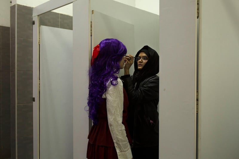 A woman applies makeup on a contestant in a costume competition at EgyCon, an annual convention for comics enthusiasts, in Cairo. AP Photo
