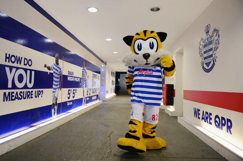 Spark, the QPR club mascot walks out of the tunnel ahead of the club's Premier League match against Burnley on Saturday. Jamie McDonald / Getty Images