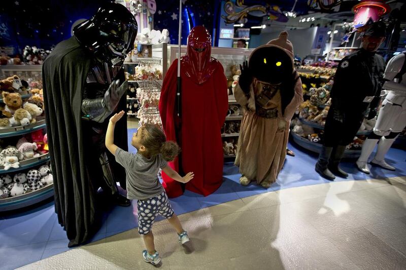 A man dressed as Darth Vader from “Star Wars” high fives a child in Times Square, New York City. Carlo Allegri / Reuters