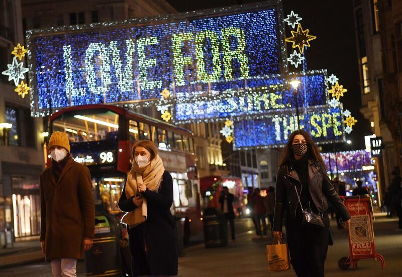 Shoppers pass Christmas lights on Oxford Street in London. EPA