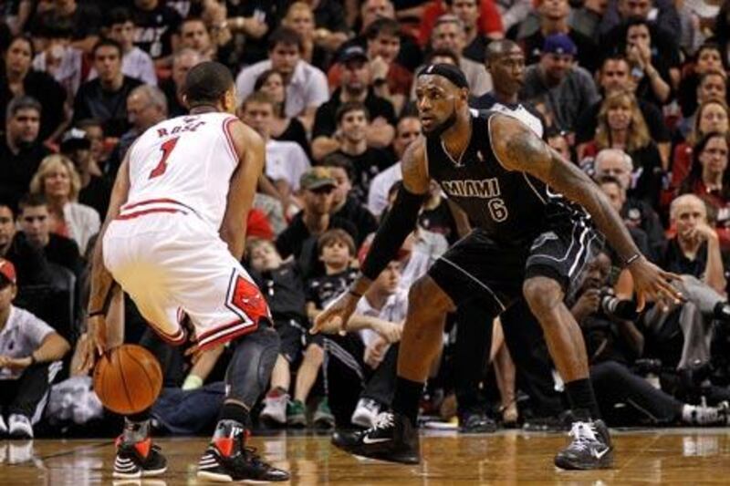 Derrick Rose, left, missed chances to win the match for the Chicago Bulls against Miami Heat and LeBron James, right,