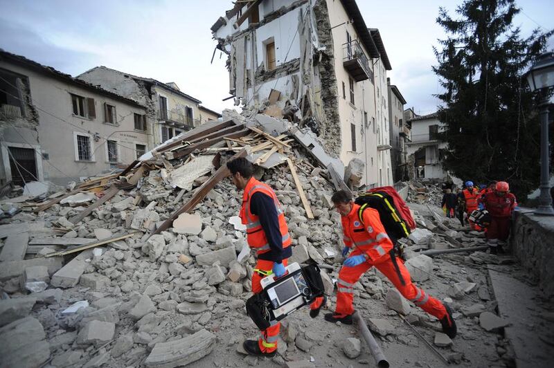 Rescuers search a crumbled building in Arcuata del Tronto, central Italy. The quake was felt across a broad section of central Italy, including the capital Rome where people in homes in the historic centre felt a long swaying followed by aftershocks. Sandro Perozzi / AP