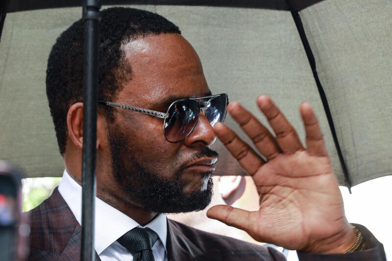 FILE - In this June 26, 2019, file photo, Musician R. Kelly departs from the Leighton Criminal Court building after a status hearing in his criminal sexual abuse trial in Chicago. Lawyers for Kelly are asking a judge in Chicago to fine and jail his ex-wife for breaking a confidentiality clause in their divorce agreement. The Chicago Sun-Times reports that Kelly's attorney Steve Greenberg said in a Tuesday, July 2, 2019, filing that Andrea Kelly appeared "on countless media outlets disparaging Robert Kelly and making accusations and charges." (AP Photo/Amr Alfiky, File)