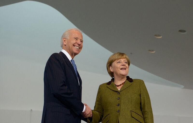 In this file photo taken on February 1, 2013, Joe Biden and Angela Merkel shake hands at the Chancellery in Berlin. AFP